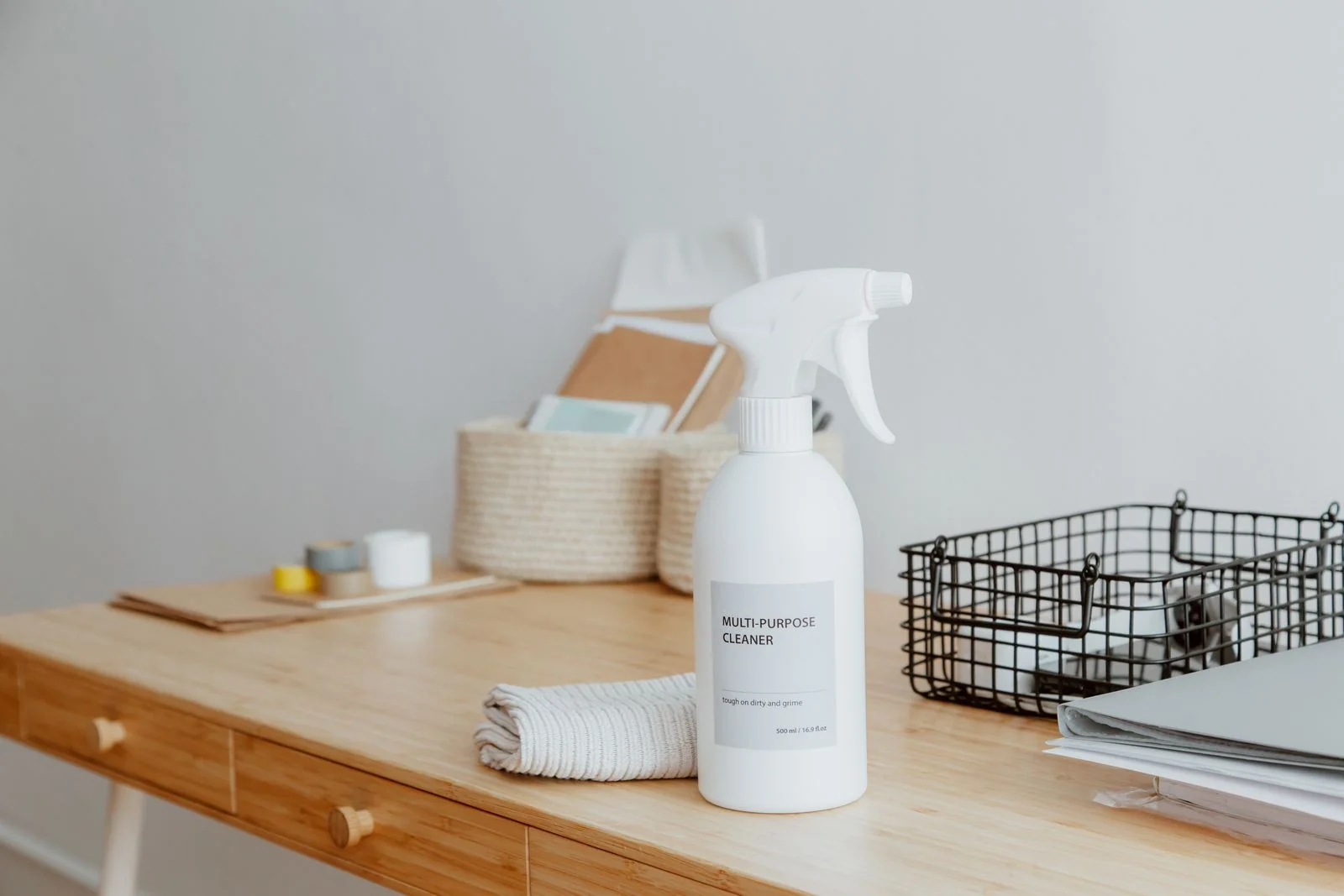 Cleaning supplies arranged on a desk.