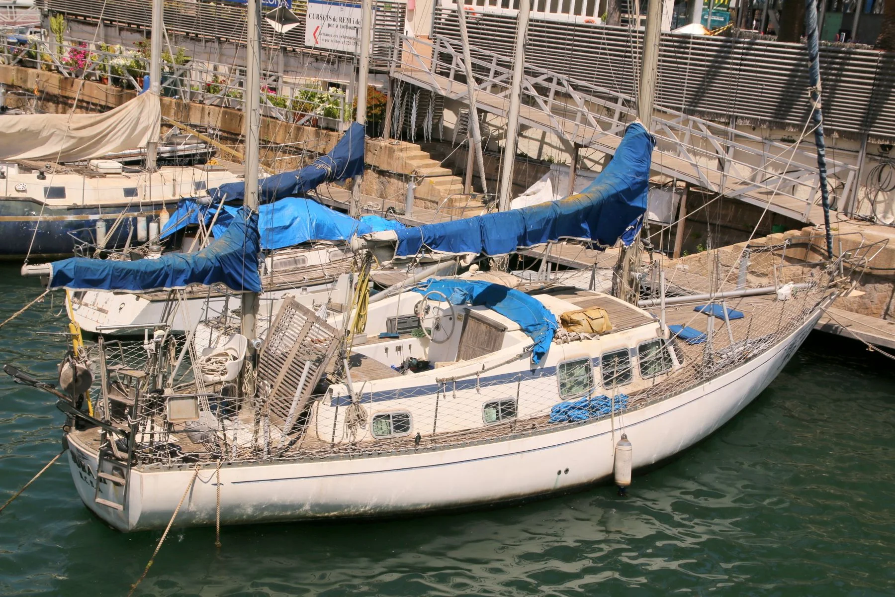 Sailboat moored in a marina.