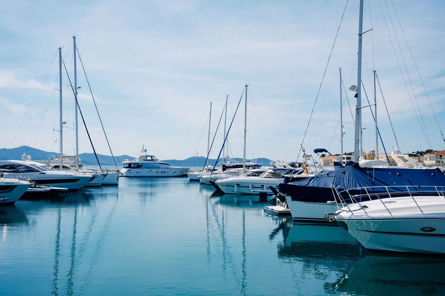 Yachts anchored on calm water.