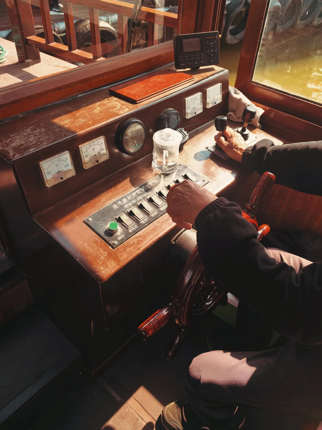 Close-up of a boat helm and navigation controls.