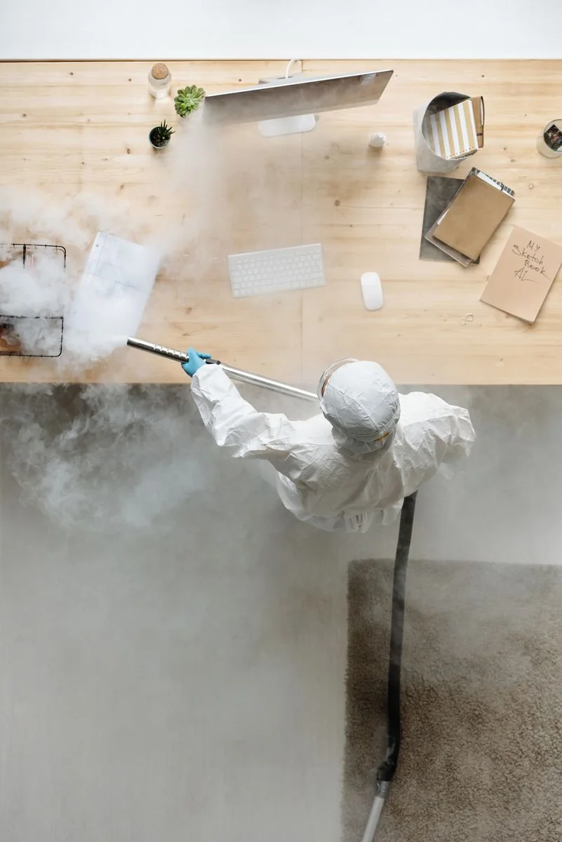 Hand cleaning a tiled bathroom surface.