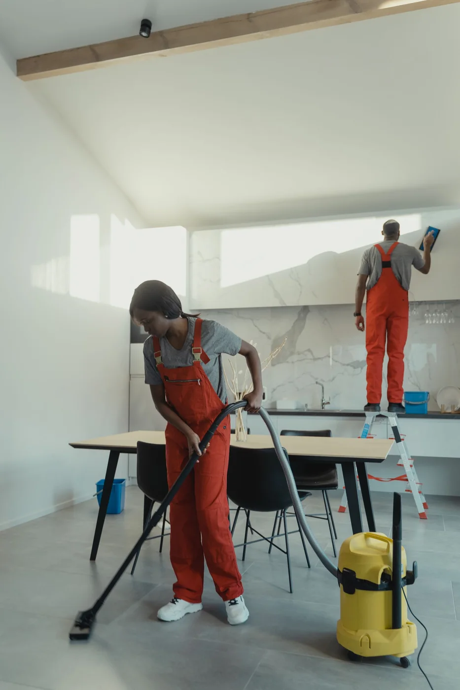 Cleaning crew working in a renovated interior.