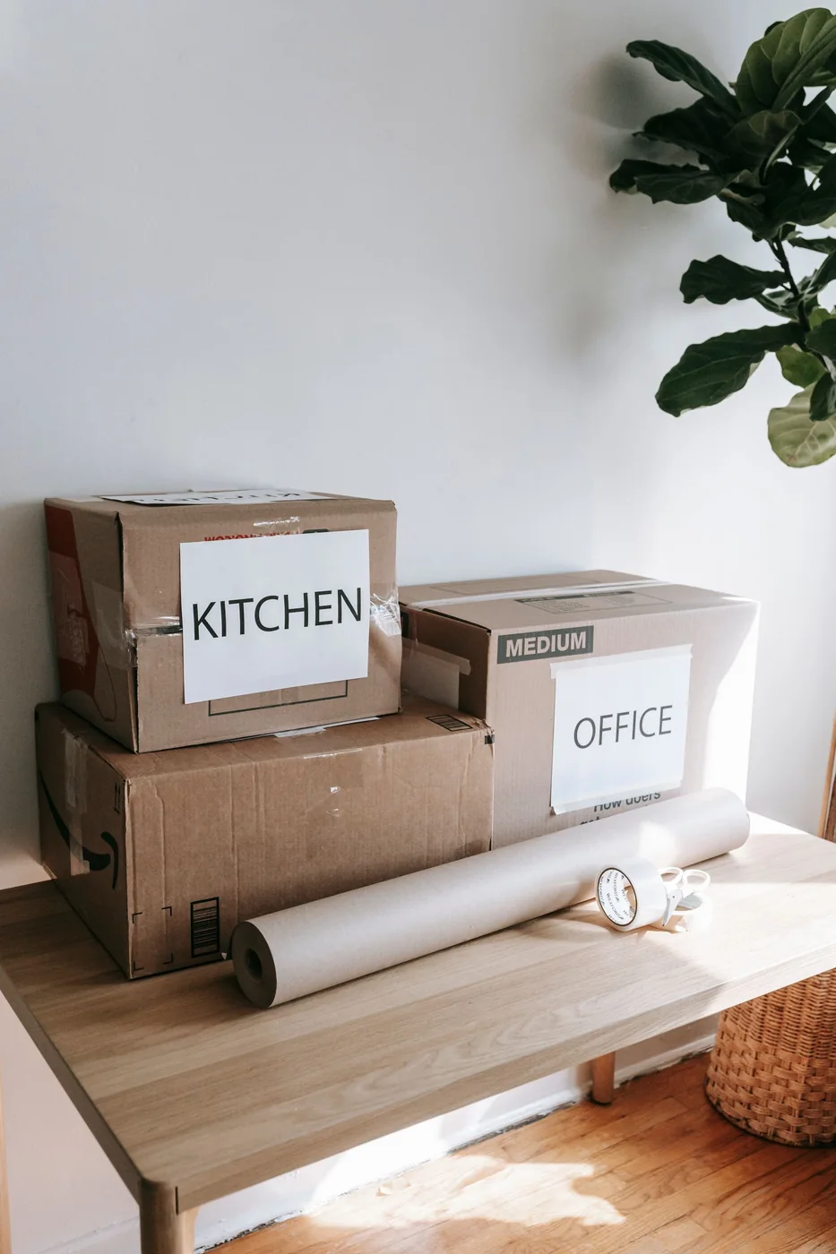 Moving boxes in a bright, empty room.
