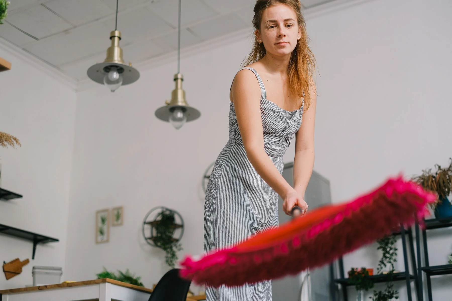 Woman mopping a wood floor at home.