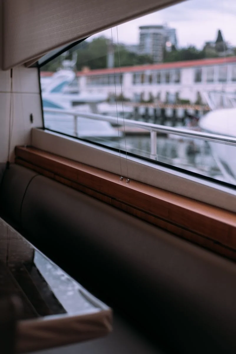 Yacht cabin windows overlooking a marina.
