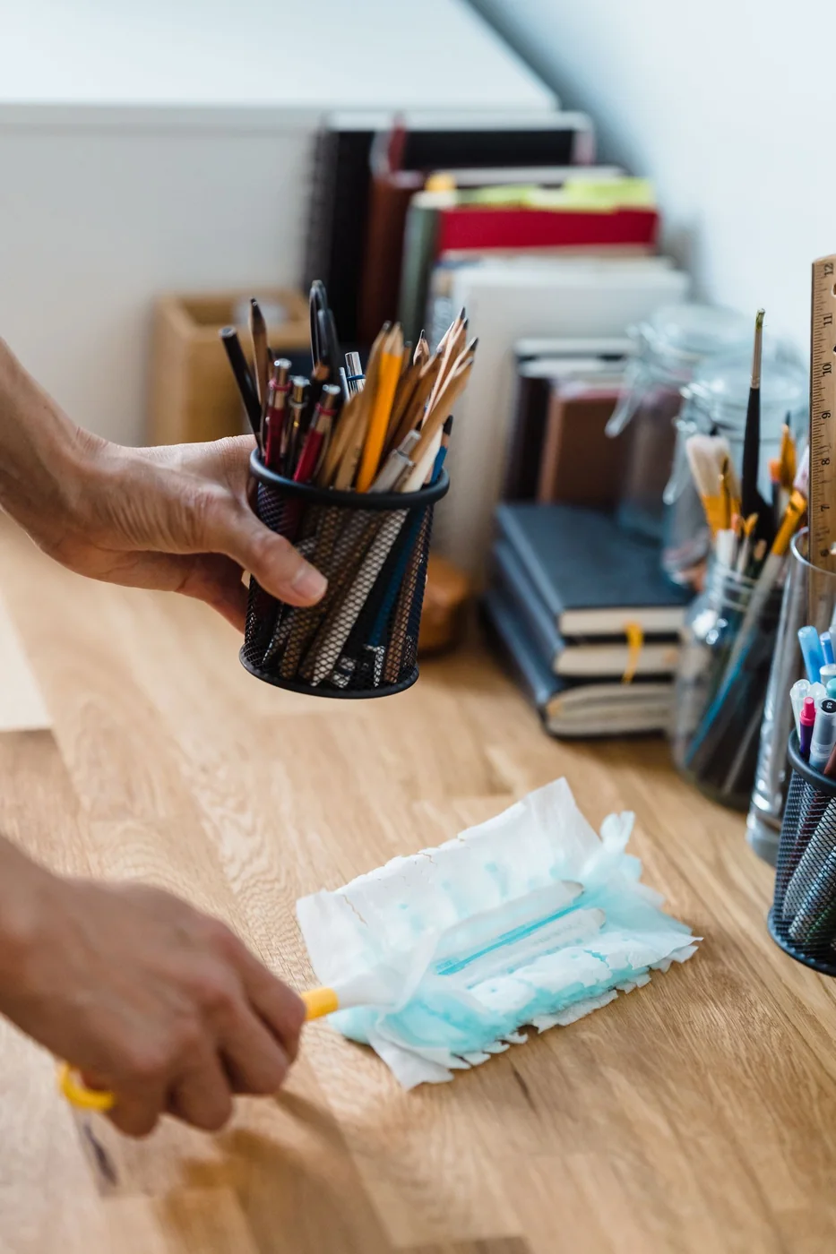 Hand cleaning an office desk.
